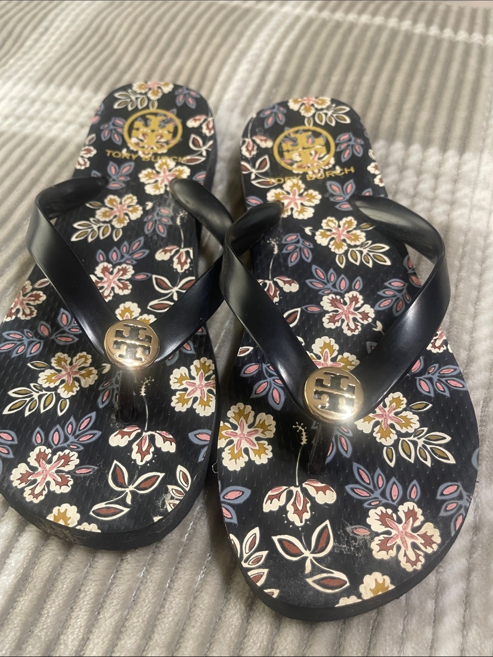 Tory Burch Black Floral Logo Flip Sandals with Gold Accents